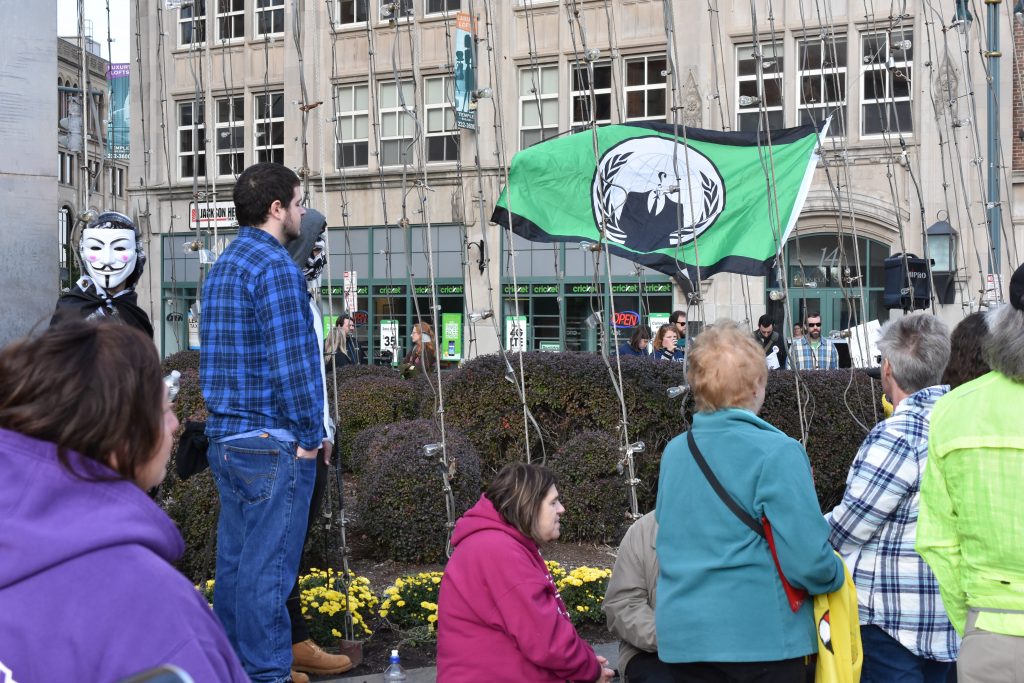 An Anonymous Flag is flown at a Standing Rock Pipeline protest in Rochester, NY to show support to the protesters.